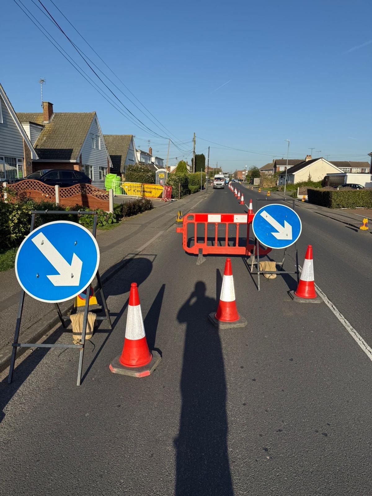 Keep left signs and cones managing traffic flow on a residential street